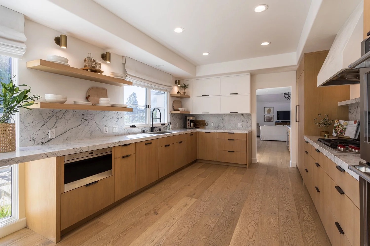 Custom Newport Beach kitchen with white oak cabinetry and natural stone designed by KADI Design